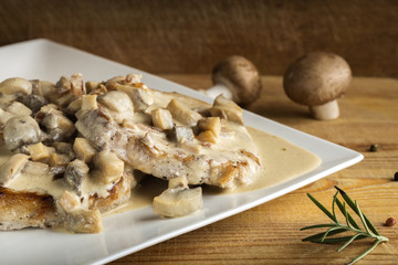 Pork sirloin with white sauce made from sour cream and mushrooms