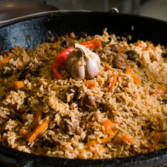 ethnic cuisine. The dish of pilaf. Traditional Uzbek food. Meat and rice plov meal