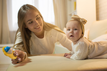 mom and daughter in the room, happy family with the baby