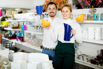 Couple choosing new crockery in dinnerware store