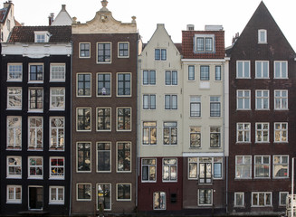 Fototapeta premium Typical gabled houses on Damrak street in Amsterdam, Holland, Netherlands