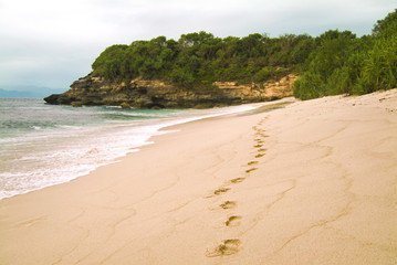 Deserted Bali Beach with Footprints. A beautiful tropical pristine beach with golden yellow sand seen on the island of Nusa Lembongan just off the coast of mainland Bali, Indonesia. 
