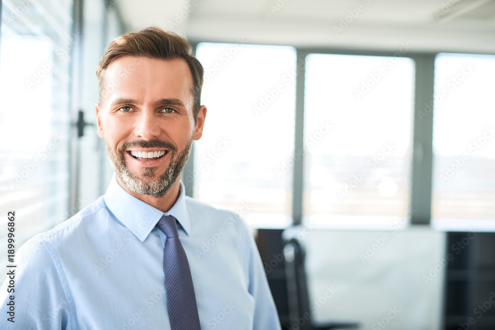 Sticker Portrait of happy businessman smiling at office