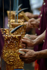 Balinese Gamelan Musician Playing a Percussion Instrument. A gamelan orchestra plays at a cremation ceremony in the village of Sanur in south Bali, Indonesia.