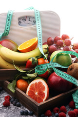 Healthy living or Diet concept. Fruits with measuring tape and a weight scale