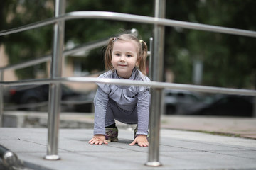 Children on a walk in the spring in the city park. The girl is w