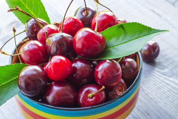 Cherry berries on a wooden background. Close-up. Selective focus.