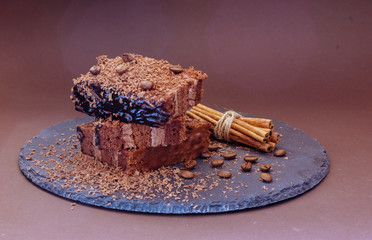 Layered chocolate cake with coffee beans and cinnamon.