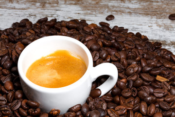 cup of coffee on roasted beans