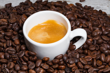 cup of coffee on roasted beans