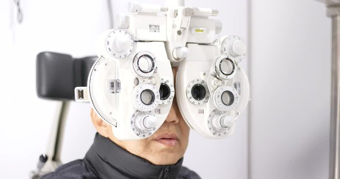 Old man undergo eye test in clinic