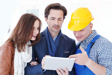 Worker and couple using tablet pc