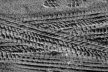 Foto op Canvas Tyre tracks on sand in black and white. © pavelalexeev