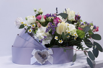 Flower composition from eustoma, tulips, lavender and eucalyptus. Bouquet for the birth of a child.