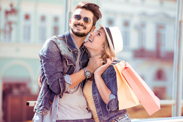 Young couple holding a shopping bags in the city.