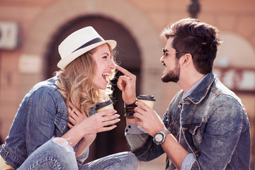 Young couple drink coffee to go and having fun.