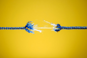 Tension, stress and risk concept - damaged rope - obrazy, fototapety, plakaty