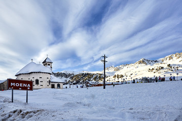 Passo San Pellegrino. Little church situated in the Dolomites, at Passo San Pellegrino. Ski resort, Ski slope. Mountains alps. Moena, Italy, Alps. Snowy winter Alps mountains at sunny day.