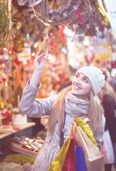 Happy smiling girl choosing Christmas decoration