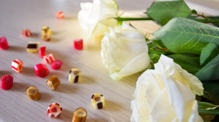 White roses and candies.