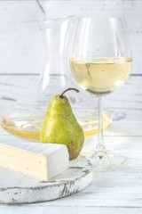 Glass of white wine with cheese and pears