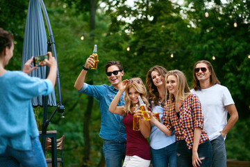 Group Of Friends Taking Photos Outdoors.