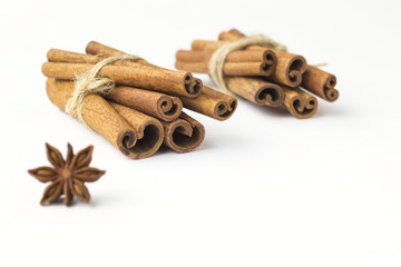 Obraz na płótnie Canvas Spices: star anise and cinnamon sticks on white background. Close up.