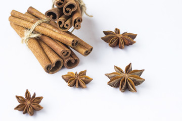 Spices: star anise and cinnamon sticks on white background. Close up.
