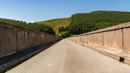 Road over the dam of Nant-y-Moch Reservoir, Ceredigion, Dyfed, Wales, UK