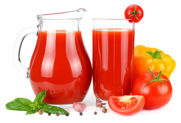 Tomato juice in glass jug with tomato, garlic, spices, and basil isolated on white background