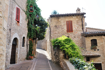 Fototapeta na wymiar Medieval street in the Italian hill town of Assisi. The traditional italian medieval historic center in Umbria. Italy