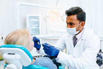 young confident asian male dentist Medical treatment to a female patient at the clinic. Dental clinic concept. - 190012020
