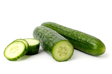 Ripe cucumbers half and sliced pieces on a white background.