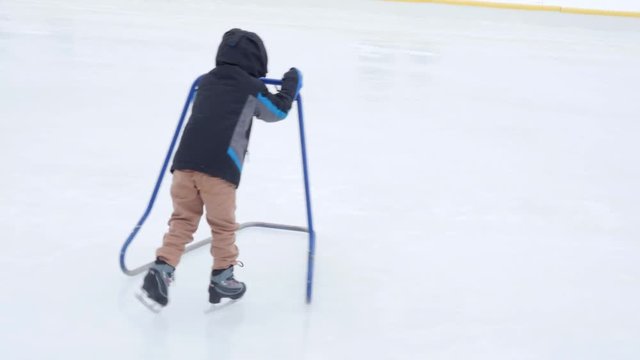Boy ice skating with his family