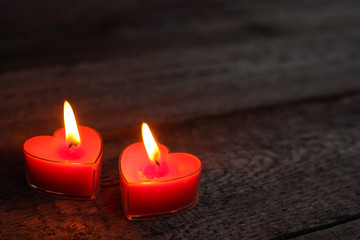 Heart shaped candles burning