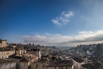 Fototapeta na wymiar Panorama of the medieval city of Saint Emilion, France with the wineyards in background, during a sunny afternoon. Saint Emilion, famous for its Bordeaux wines, is one of the oldest cities of the area
