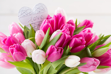 Pink tulip on the white background. Easter background