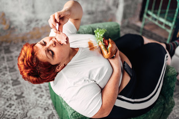 Overweight woman eats sandwich, bulimic, obesity