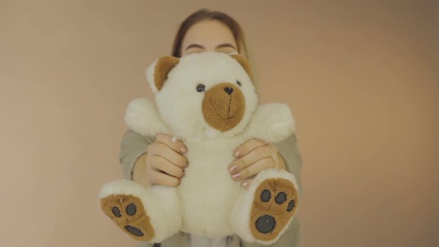 Young pretty woman with teddy bear, studio  