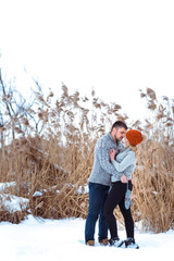 loving couple walking together in winter on the street