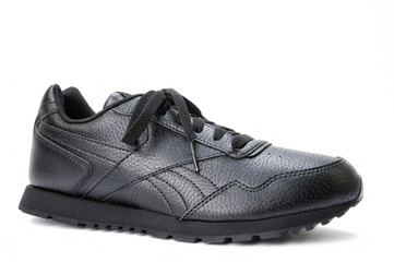 Black women's sports shoe on a white background.