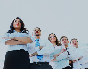 Obraz premium Happy young business woman with her team in background.