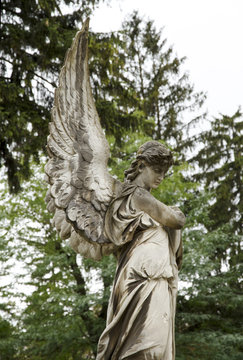 Angel woman old sculpture at a grave. Lychakovsky cemetery, Lviv.