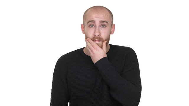 Portrait of adult bald man being surprised and shocked covering open mouth with hand, feeling horror over white background. Concept of emotions