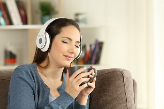 Woman relaxing drinking and listening to music