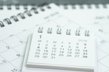 Clean white calendar business deadline, time passing, year planning or appointment reminder concept by pile of white and clean paper calendars on office table