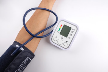 Male checking blood pressure on white background