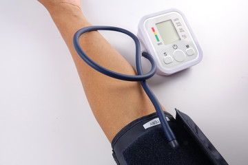 Male checking blood pressure on white background