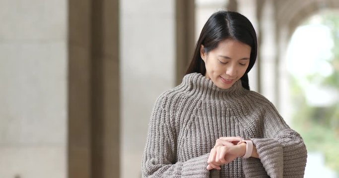 Woman use smart watch in the steet
