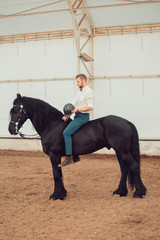man riding brown horse on the countryside